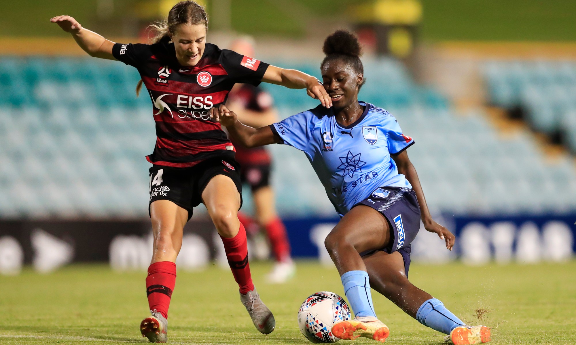 Wanderers' Courtney Nevin and Sydney FC's Princess Ibini tussle in the Sydney Derby.